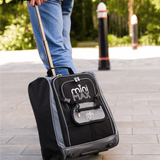 Aerolite MiniMAX black suitcase being rolled on a pavement, showcasing its lightweight design and telescopic handle.