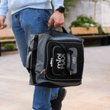 Aerolite MiniMAX black suitcase carried by hand, highlighting its compact size and versatile portability.