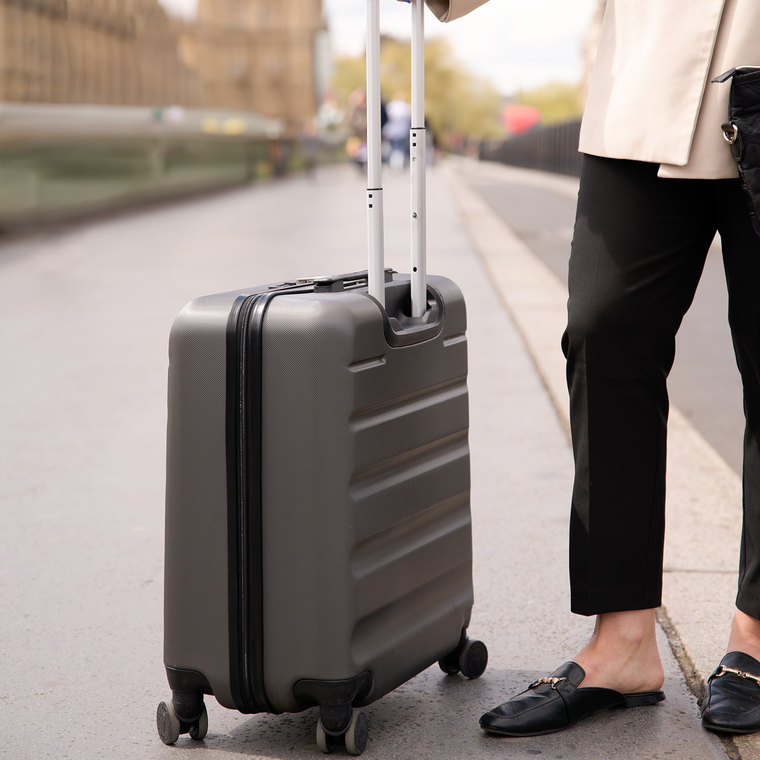 Aerolite suitcase on city street with telescopic handle