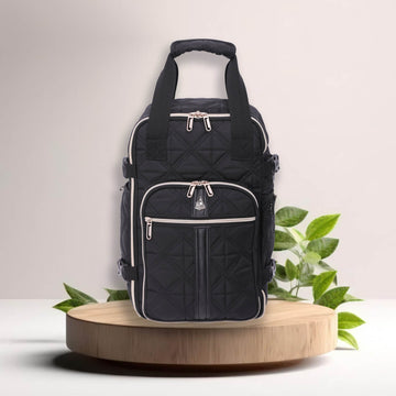 Aerolite eco-friendly backpack displayed on a wooden platform with green leaves, emphasizing its sustainable design and stylish quilted finish.