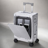 A silver Aerolite aluminum hard-shell suitcase with its front lid open, showing a black interior organizer holding a tablet. The suitcase has a textured geometric pattern, four spinner wheels, and an extended telescoping handle, set against a neutral gray studio background.